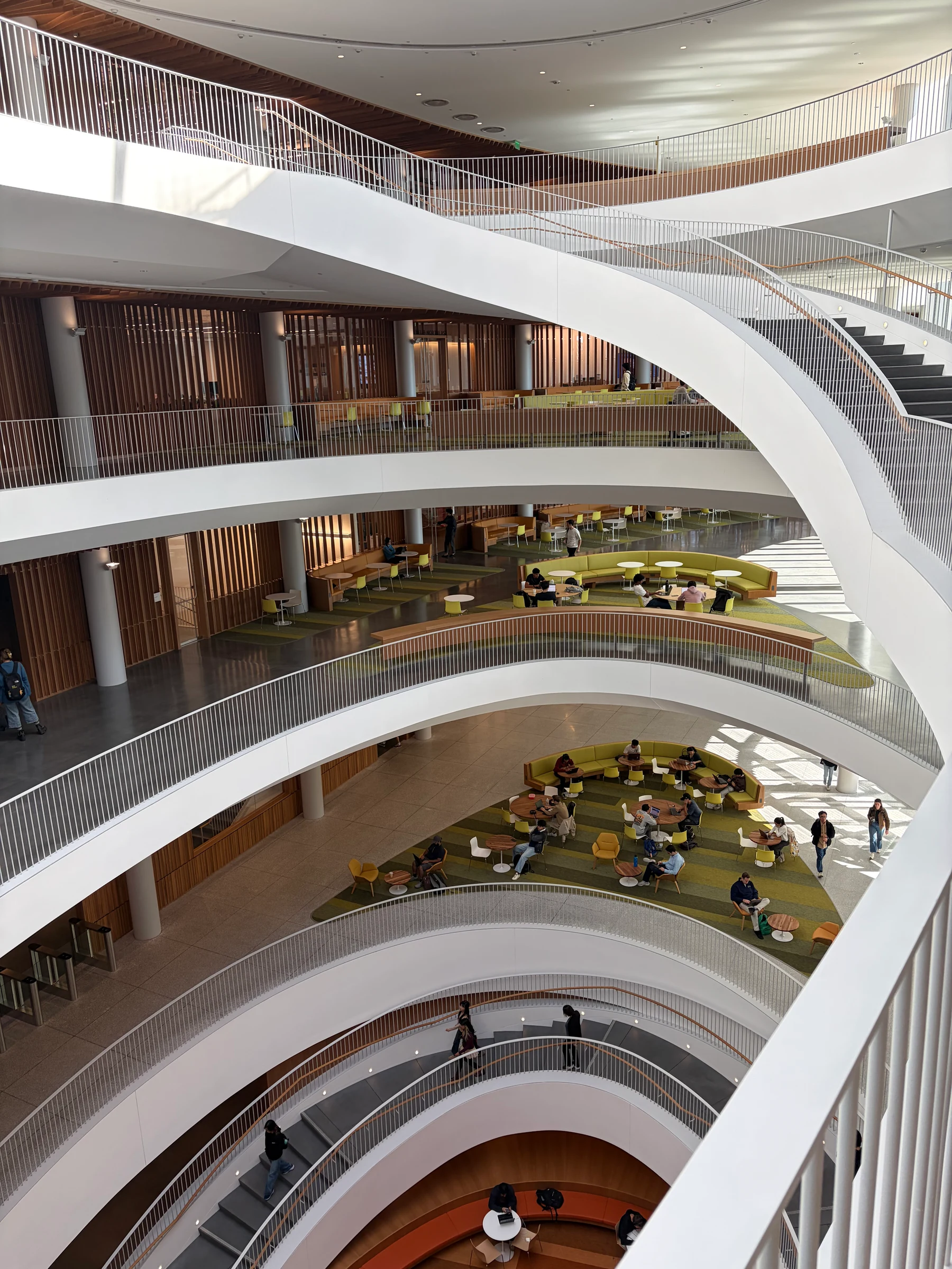 The atrium of Gateway: curving white balconies stacked floor on floor around a void that runs all the way down